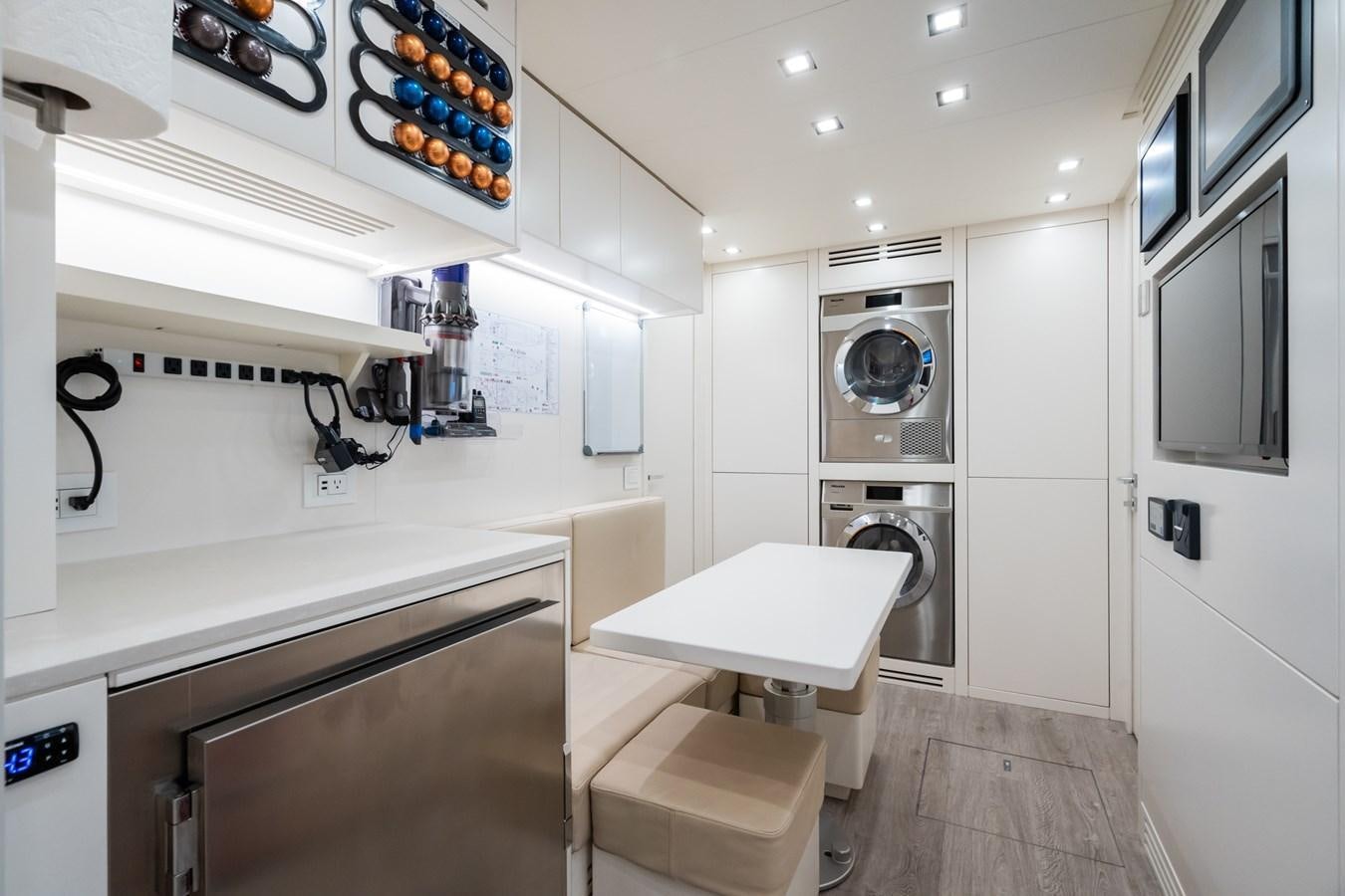 a kitchen with a table and chairs aboard JACQPOT Yacht for Sale