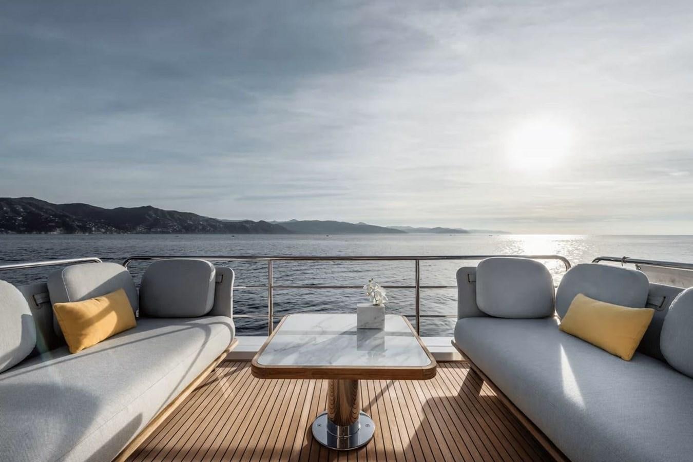 a deck with chairs and a table on it aboard 2023 AZIMUT FLY 78 Yacht for Sale