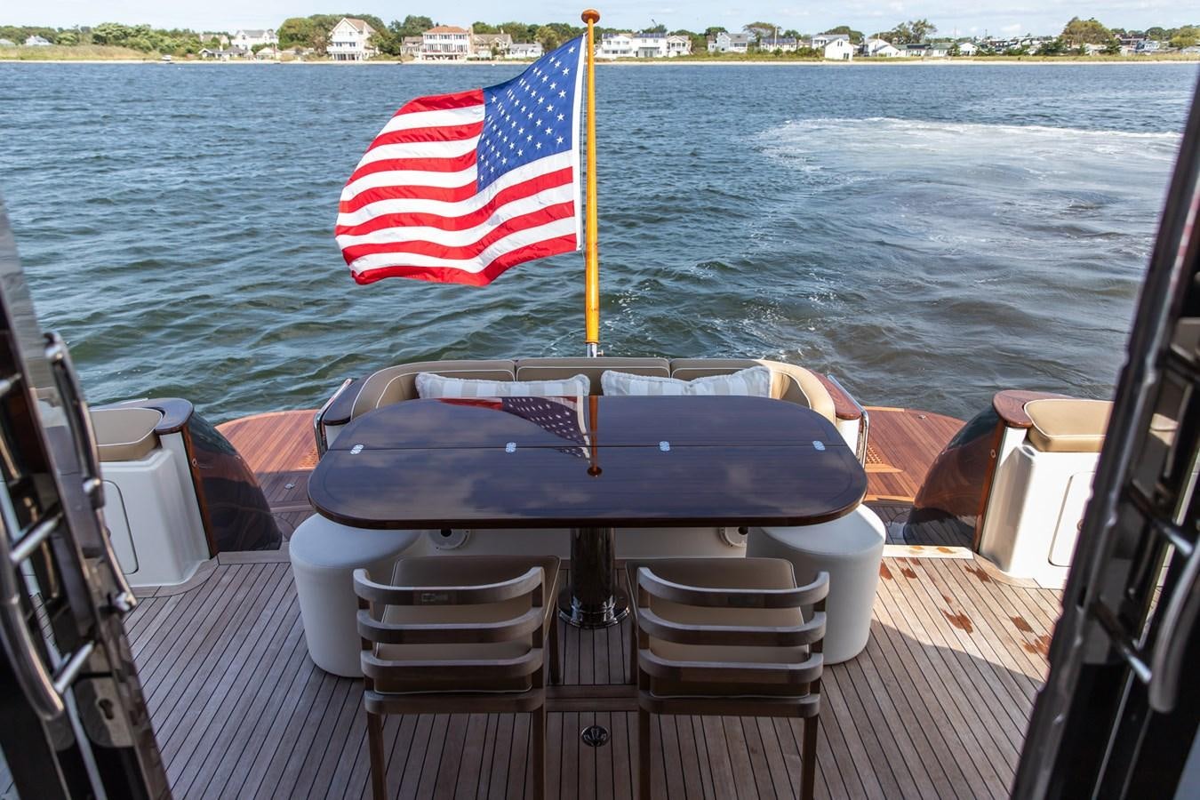 a boat with a flag on it aboard ARAGOSTA Yacht for Sale