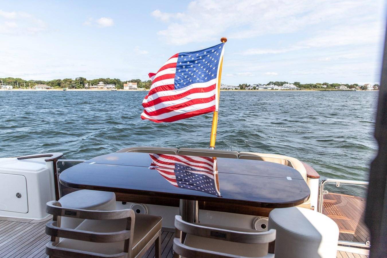 a boat with a flag on it aboard ARAGOSTA Yacht for Sale