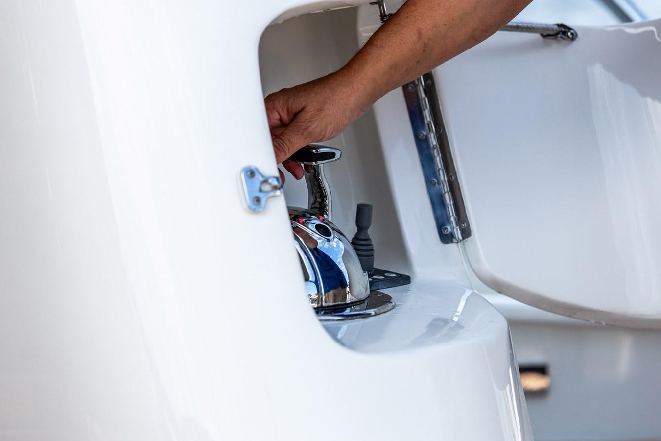 a man holding a water bottle aboard ARAGOSTA Yacht for Sale