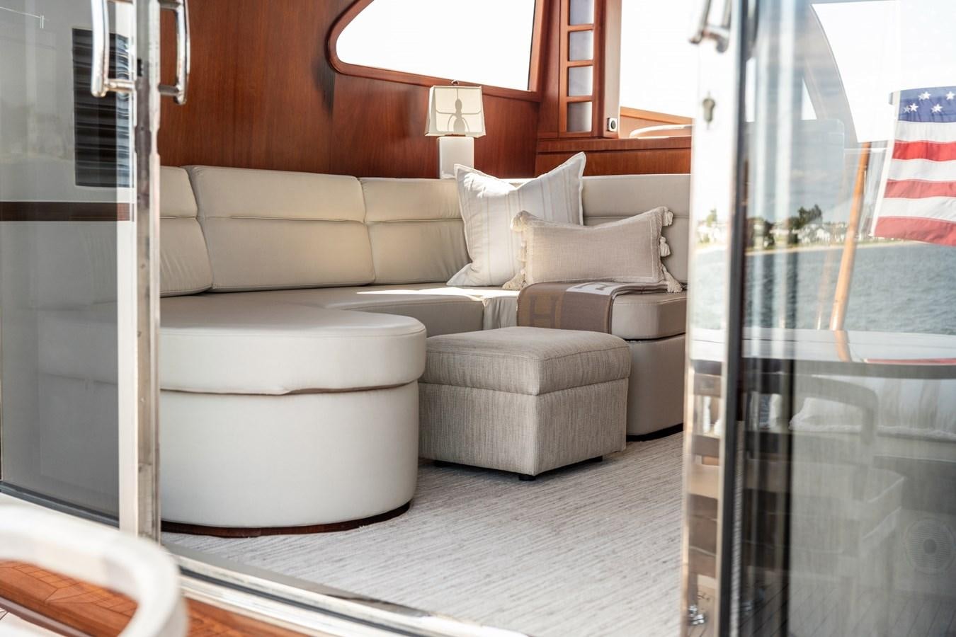 a living room with a couch and a window aboard ARAGOSTA Yacht for Sale