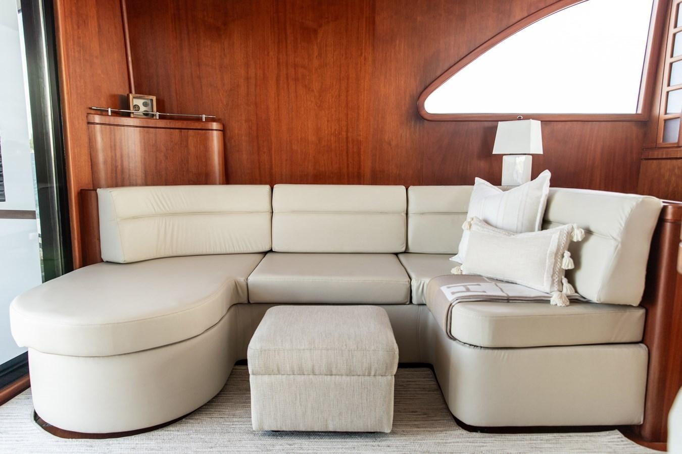 a room with a couch and a shelf aboard ARAGOSTA Yacht for Sale