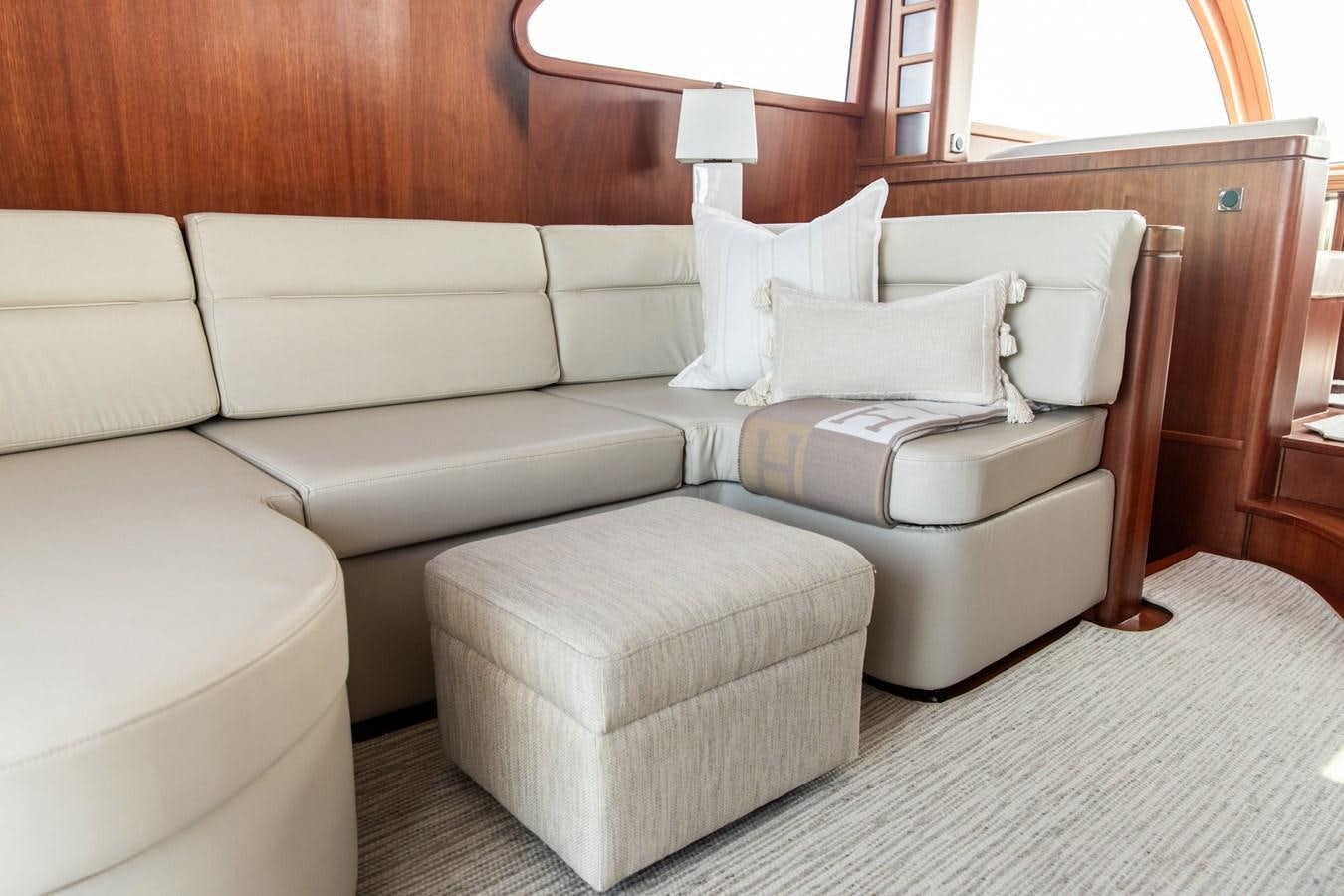 a white couch with a white pillow aboard ARAGOSTA Yacht for Sale