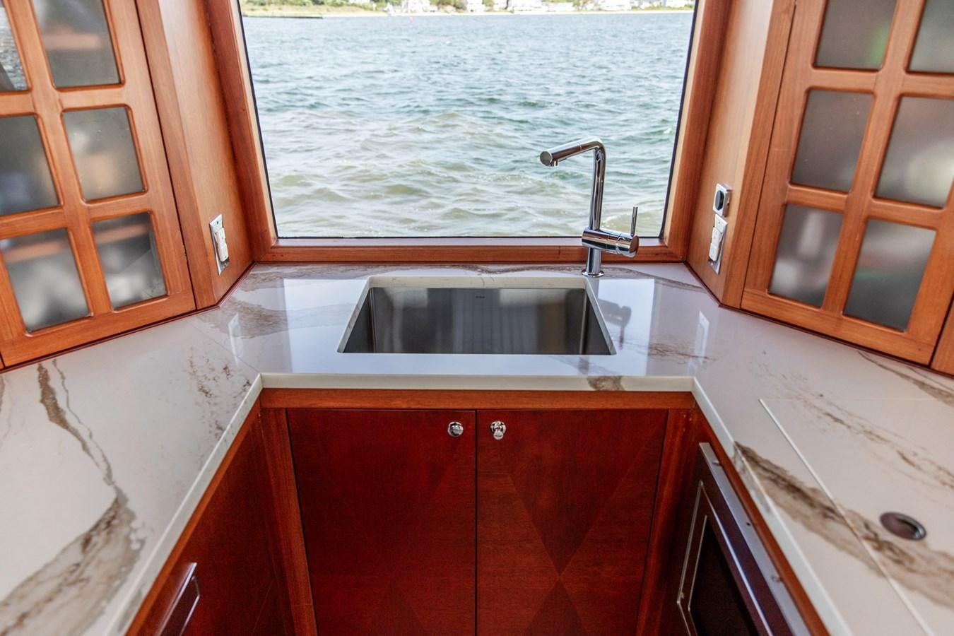 a kitchen with a sink and cabinets aboard ARAGOSTA Yacht for Sale