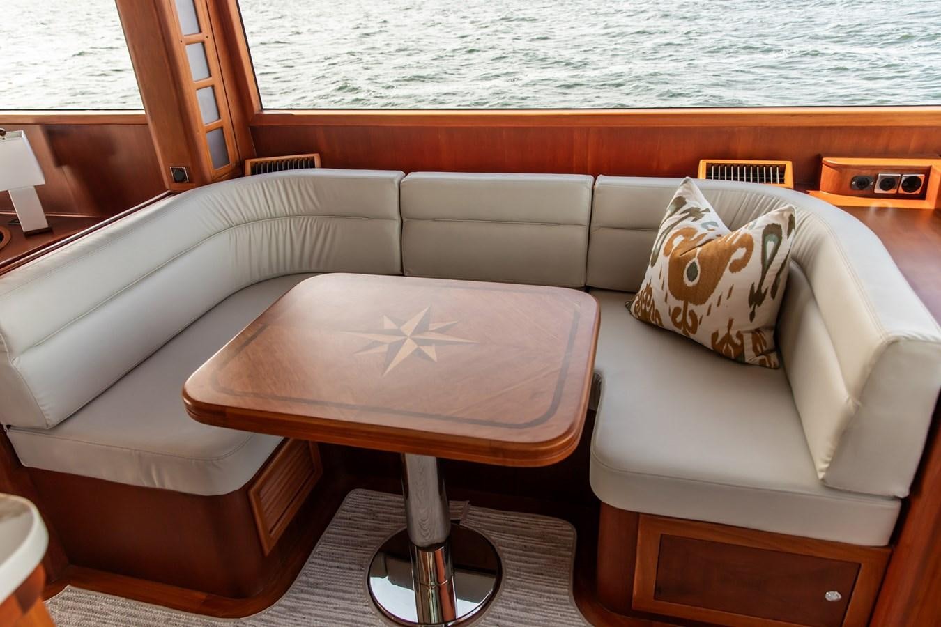 a couch with a table on it aboard ARAGOSTA Yacht for Sale