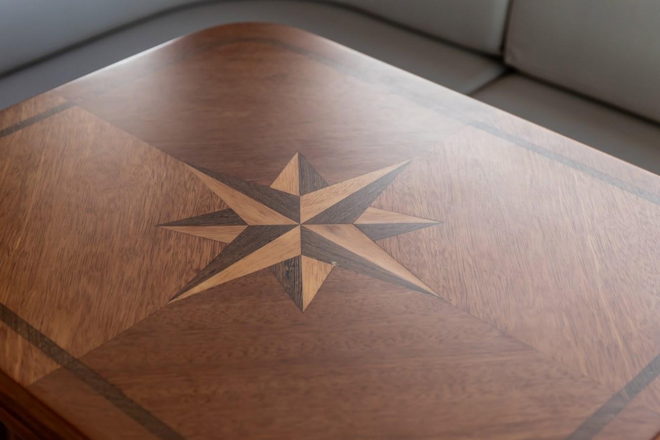 a wooden puzzle on a table aboard ARAGOSTA Yacht for Sale