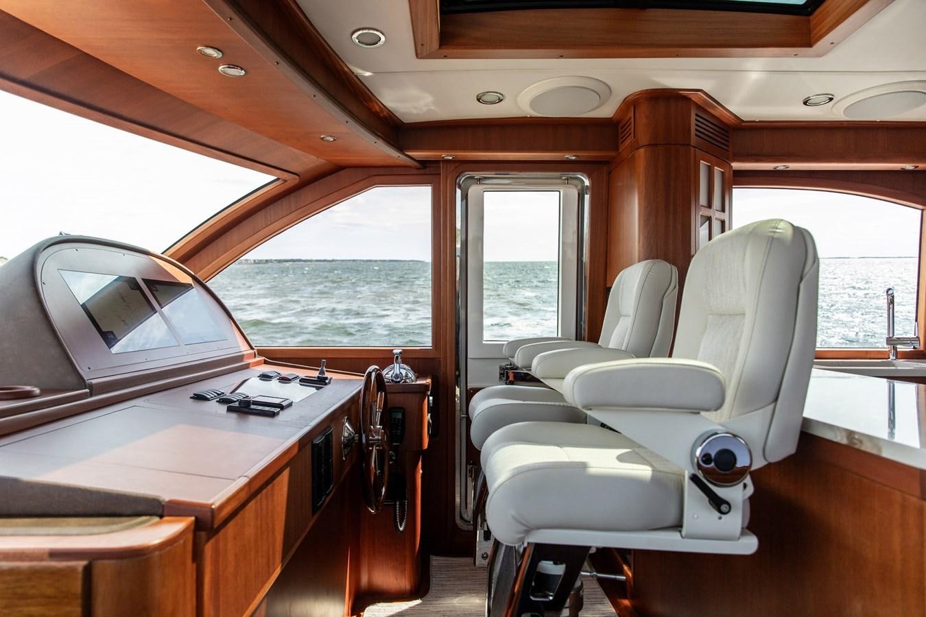 a boat with a desk and a chair aboard ARAGOSTA Yacht for Sale