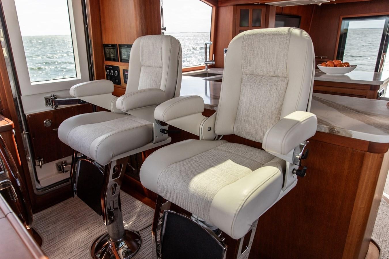 a room with chairs and a table aboard ARAGOSTA Yacht for Sale
