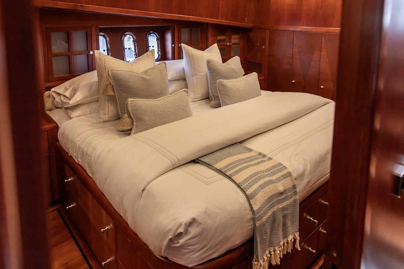 a bed with white sheets aboard ARAGOSTA Yacht for Sale