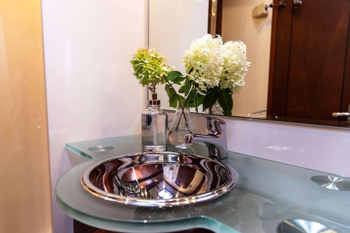 a bathroom sink with a flower vase aboard ARAGOSTA Yacht for Sale