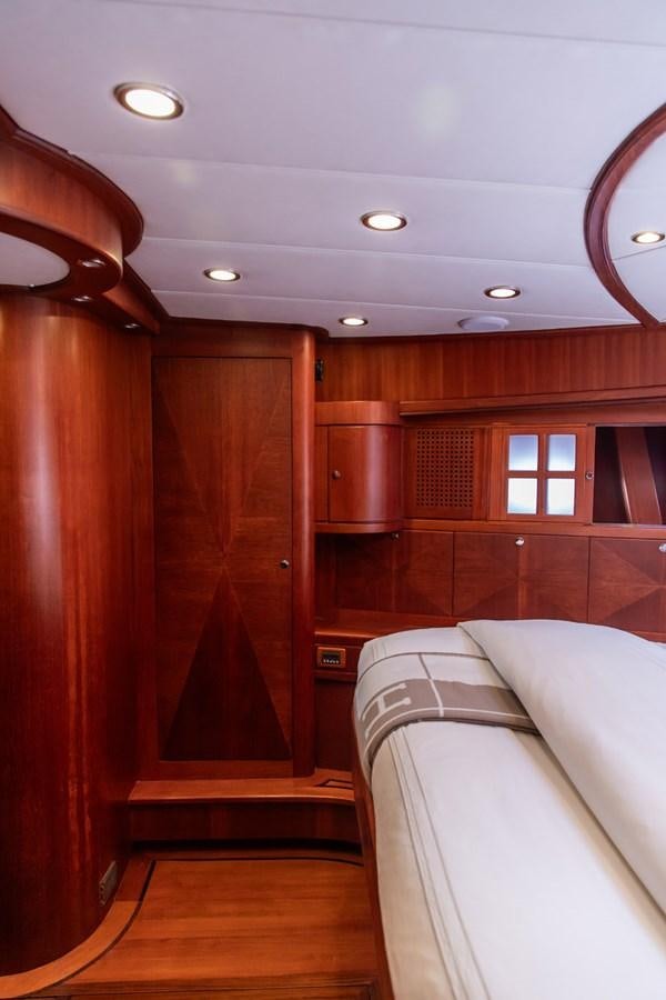 a room with a bed and a wood door aboard ARAGOSTA Yacht for Sale