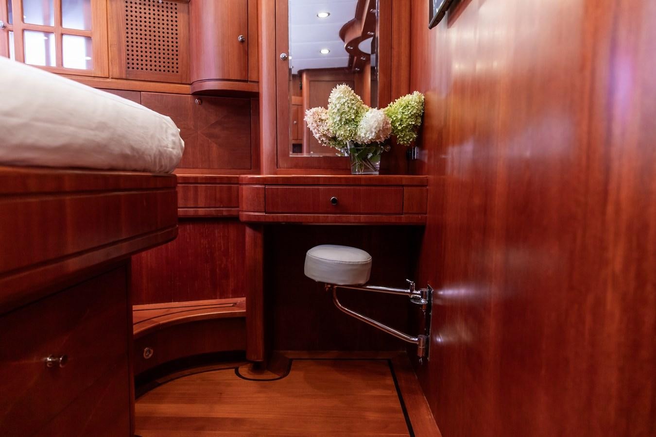 a room with a chair and a table and a mirror aboard ARAGOSTA Yacht for Sale