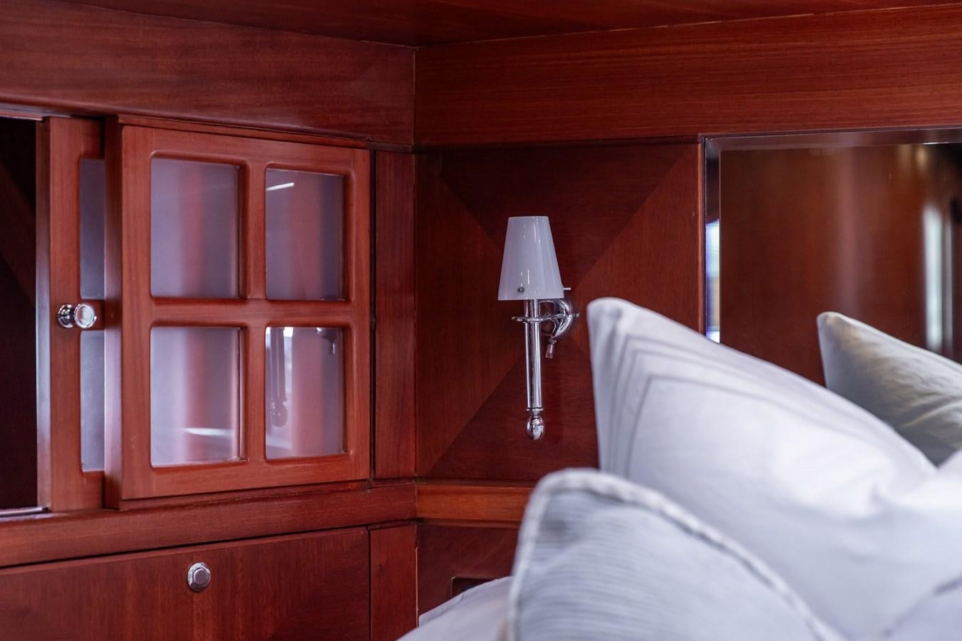 a bed with a lamp on it aboard ARAGOSTA Yacht for Sale
