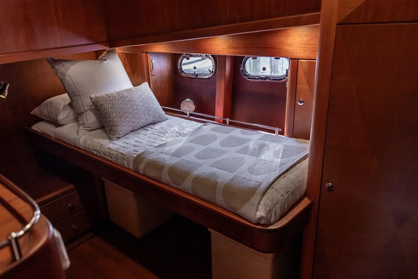 a bed with a white comforter aboard ARAGOSTA Yacht for Sale