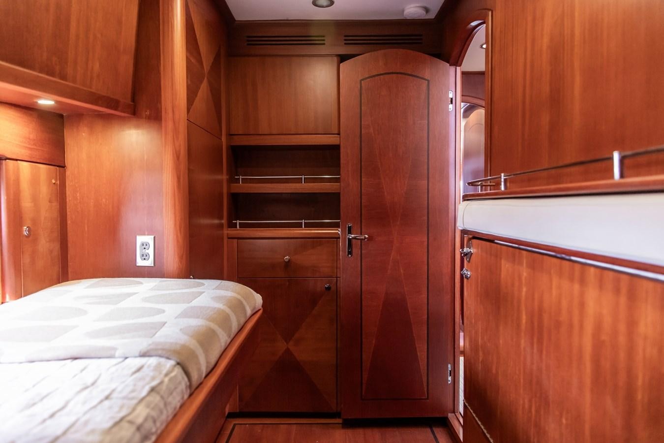 a room with a bed and a closet aboard ARAGOSTA Yacht for Sale