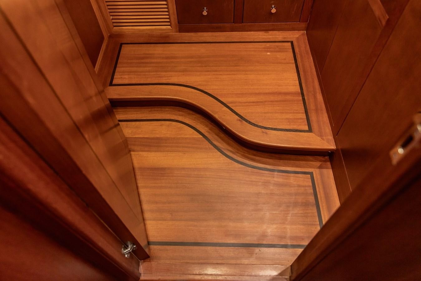 a wooden door with a glass window aboard ARAGOSTA Yacht for Sale