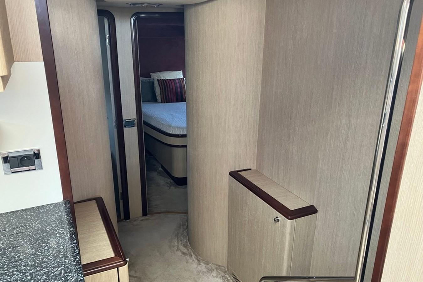 a room with a wood door and a bed aboard VINTAGE Yacht for Sale