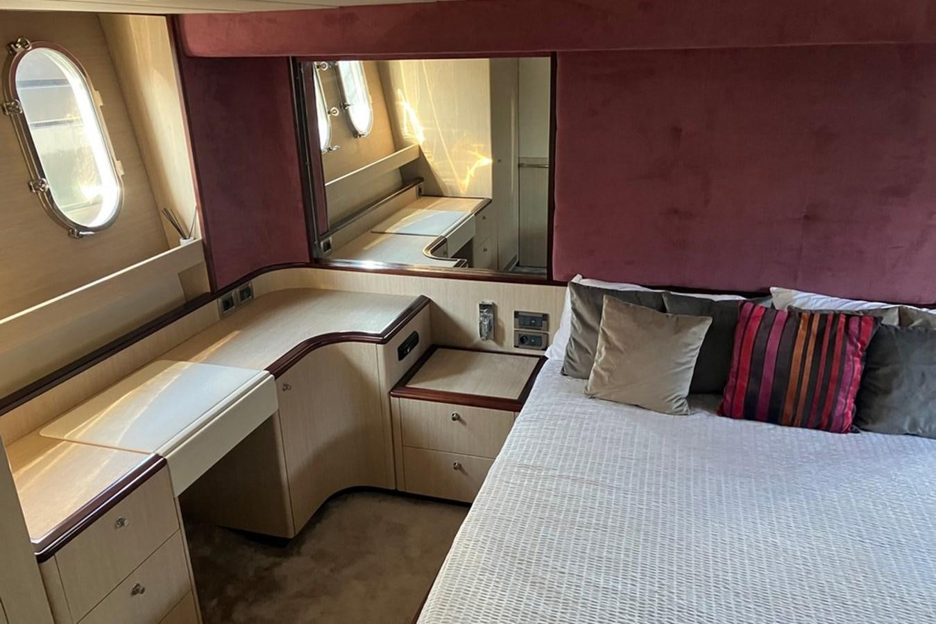 a room with a bed and a mirror aboard VINTAGE Yacht for Sale