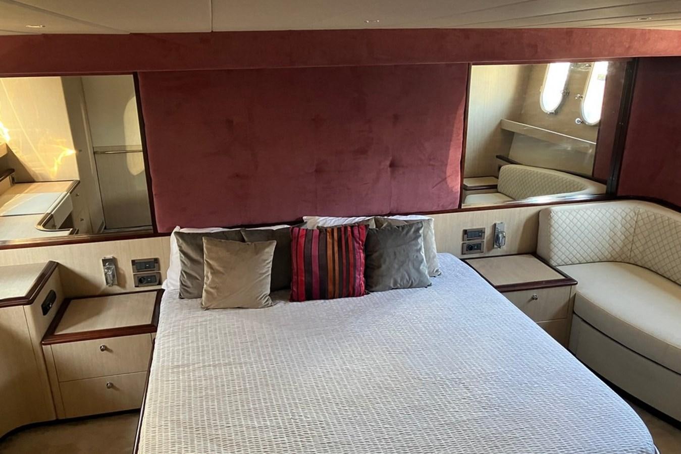 a bed with a white sheet and pillows aboard VINTAGE Yacht for Sale