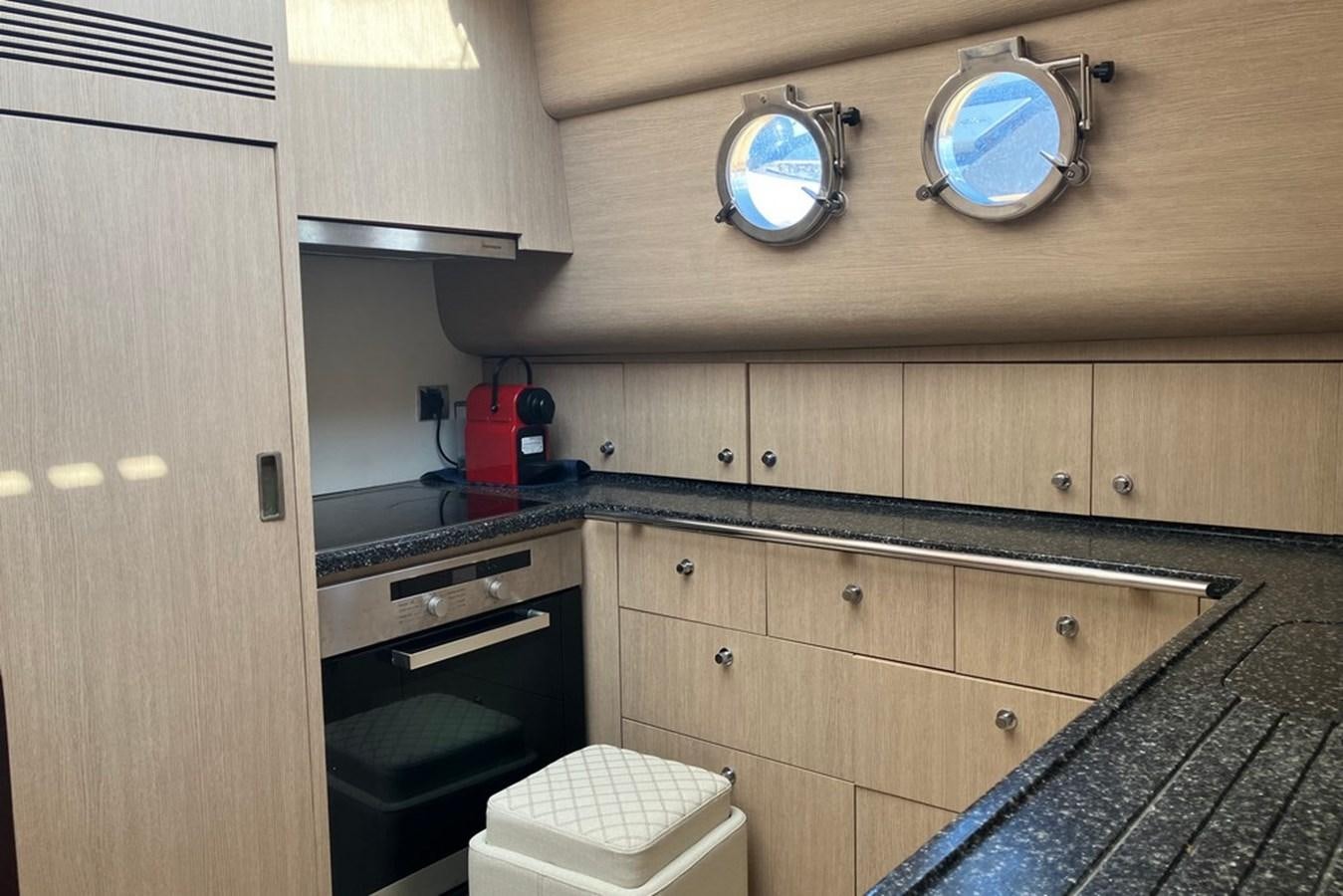 a kitchen with wooden cabinets aboard VINTAGE Yacht for Sale