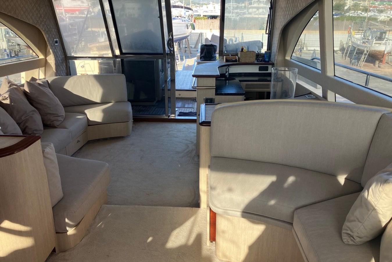 a living room with a large window aboard VINTAGE Yacht for Sale