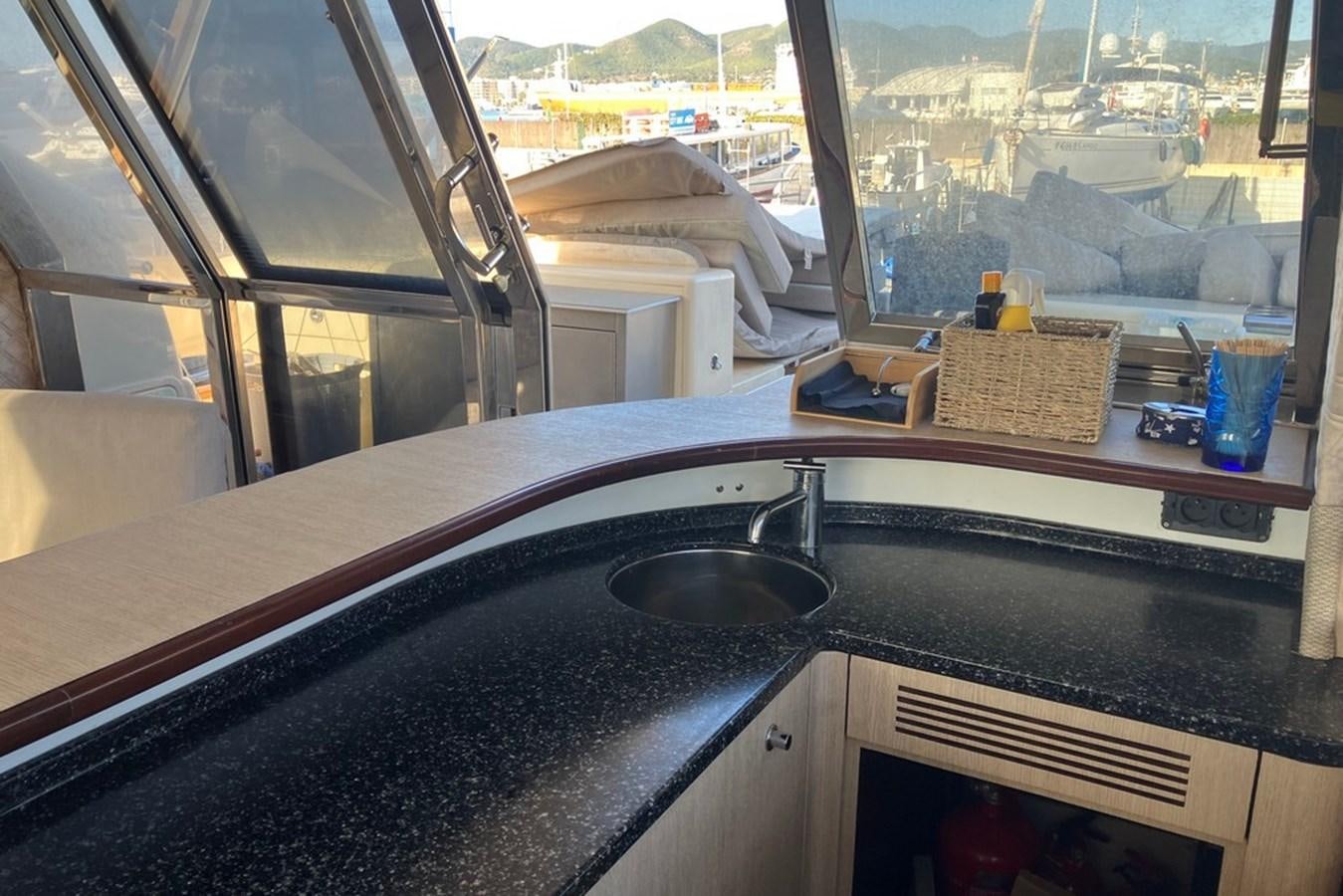 a kitchen sink with a view of the city below aboard VINTAGE Yacht for Sale