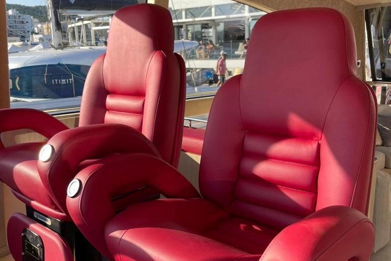 a red car seat aboard VINTAGE Yacht for Sale