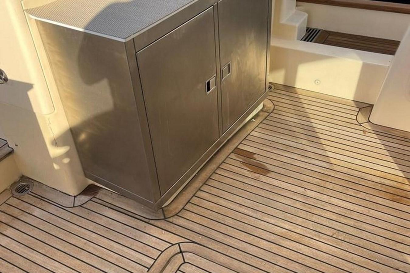 a kitchen with a large stainless steel refrigerator aboard VINTAGE Yacht for Sale