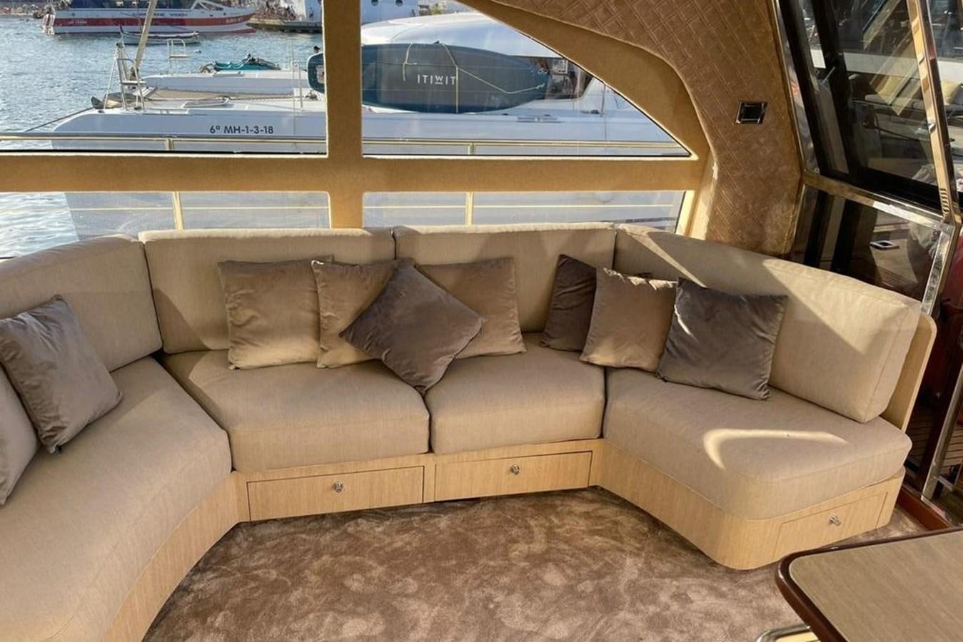 a couch with a window aboard VINTAGE Yacht for Sale