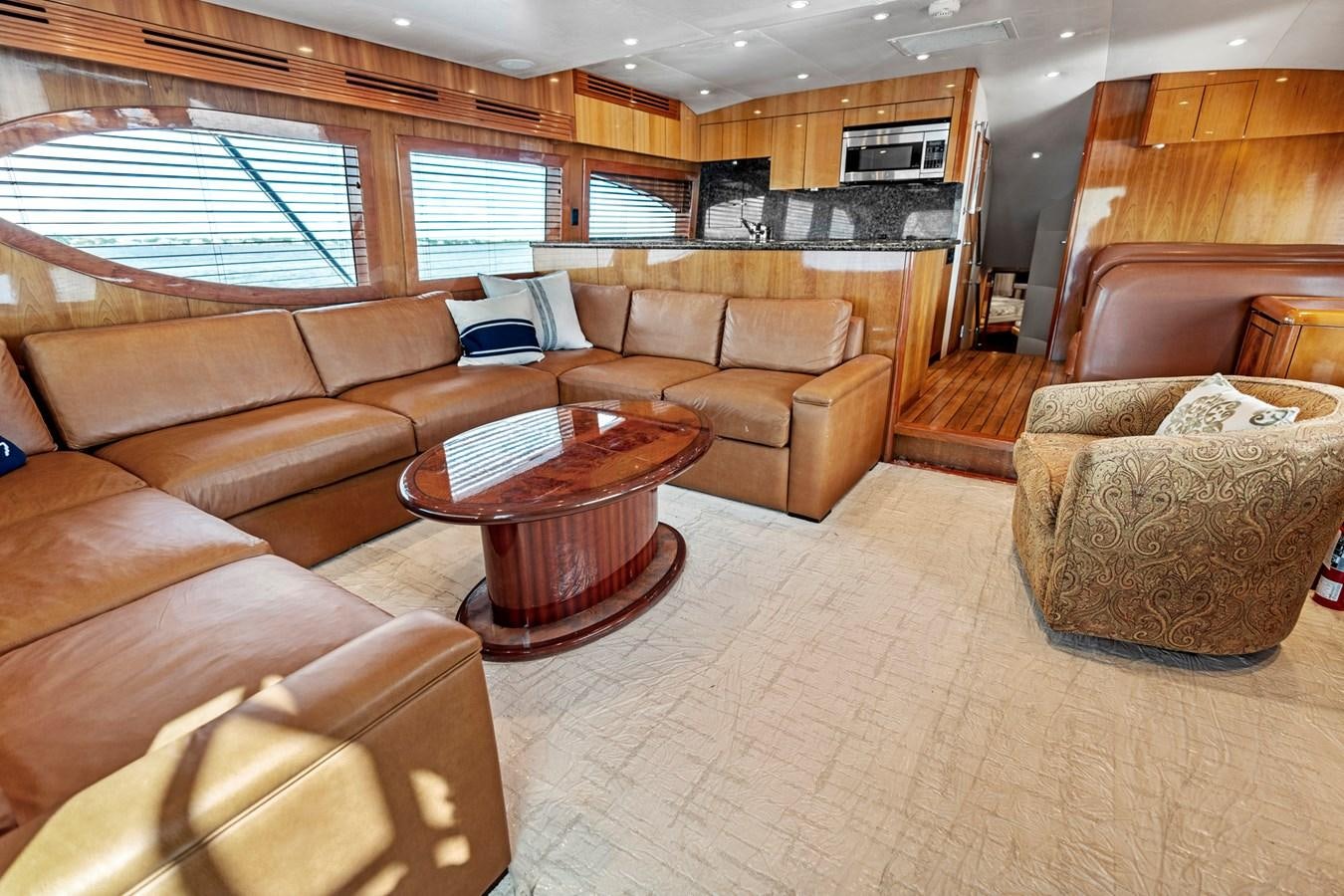 a living room with brown furniture aboard NAUTICAL NOMAD Yacht for Sale