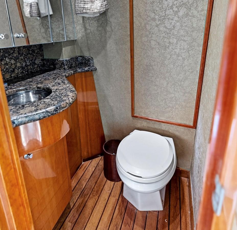 a bathroom with a toilet and sink aboard NAUTICAL NOMAD Yacht for Sale