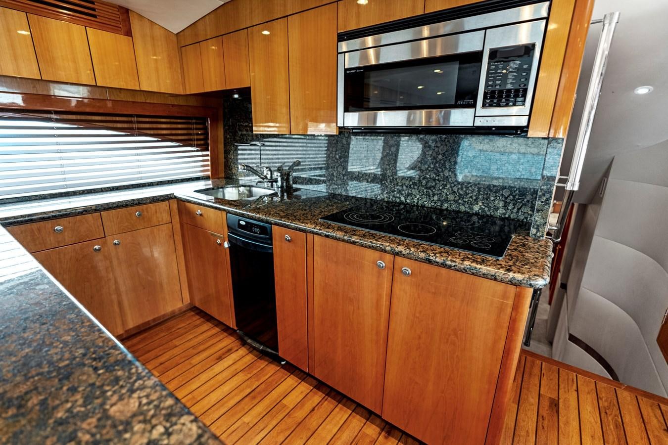 a kitchen with black appliances aboard NAUTICAL NOMAD Yacht for Sale
