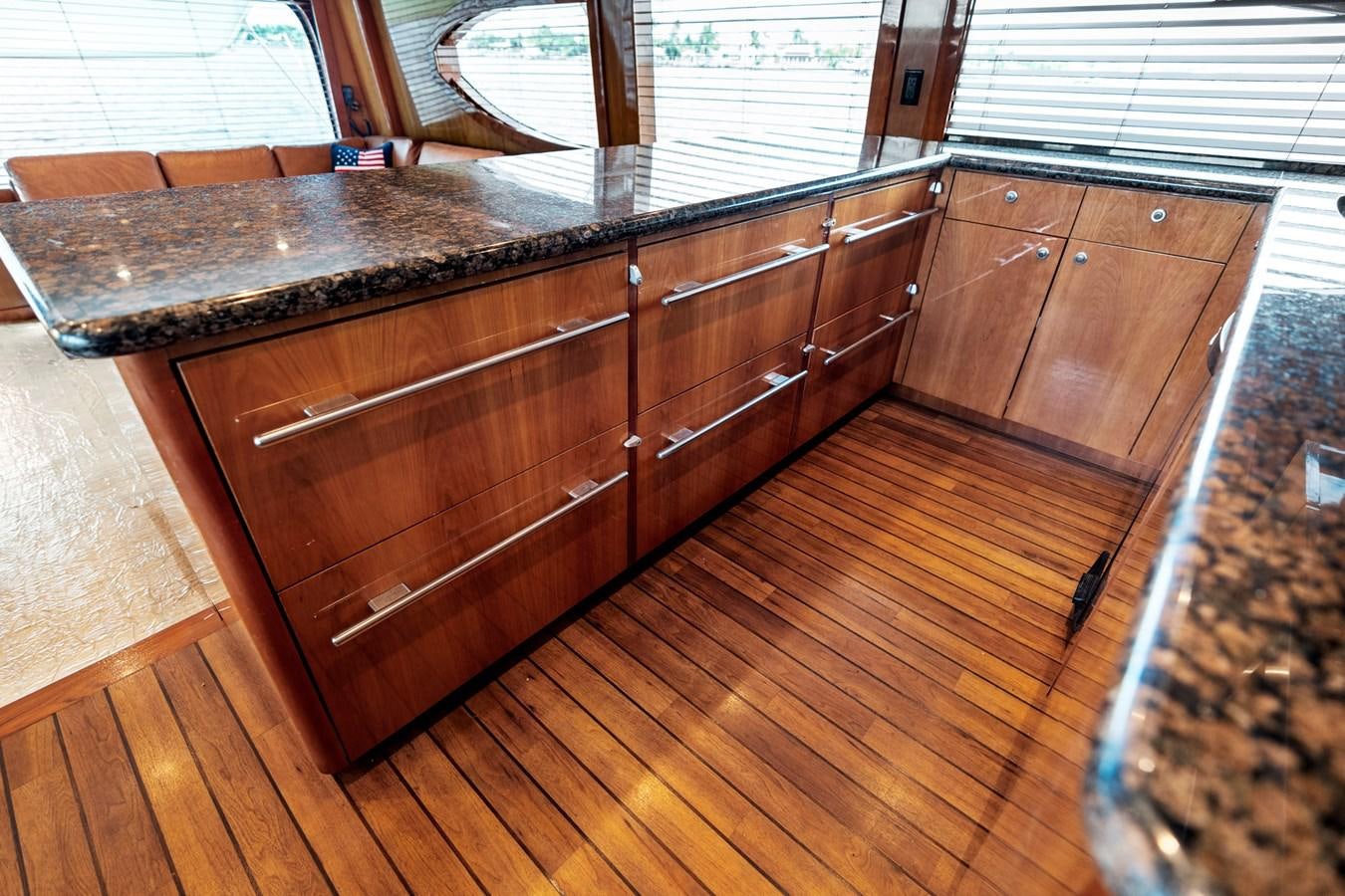 a kitchen with wooden cabinets aboard NAUTICAL NOMAD Yacht for Sale