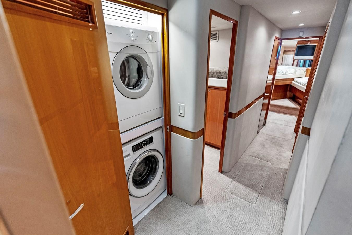 a room with a washing machine and a door aboard NAUTICAL NOMAD Yacht for Sale