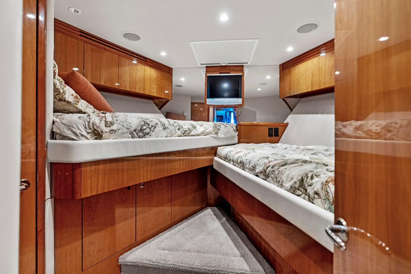 a room with a bed and a television aboard NAUTICAL NOMAD Yacht for Sale