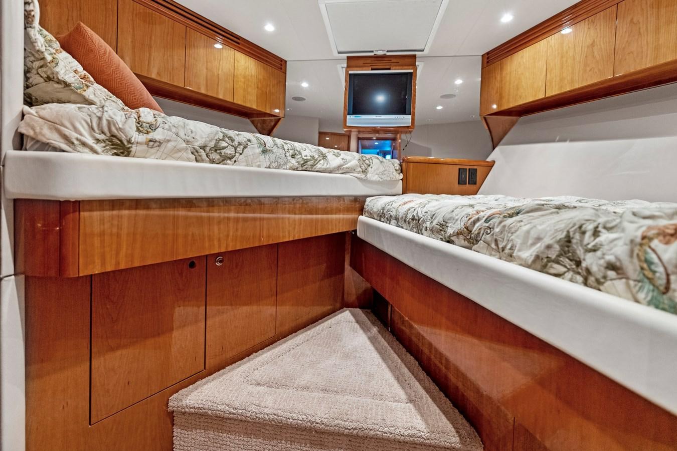 a room with a bed and a television aboard NAUTICAL NOMAD Yacht for Sale