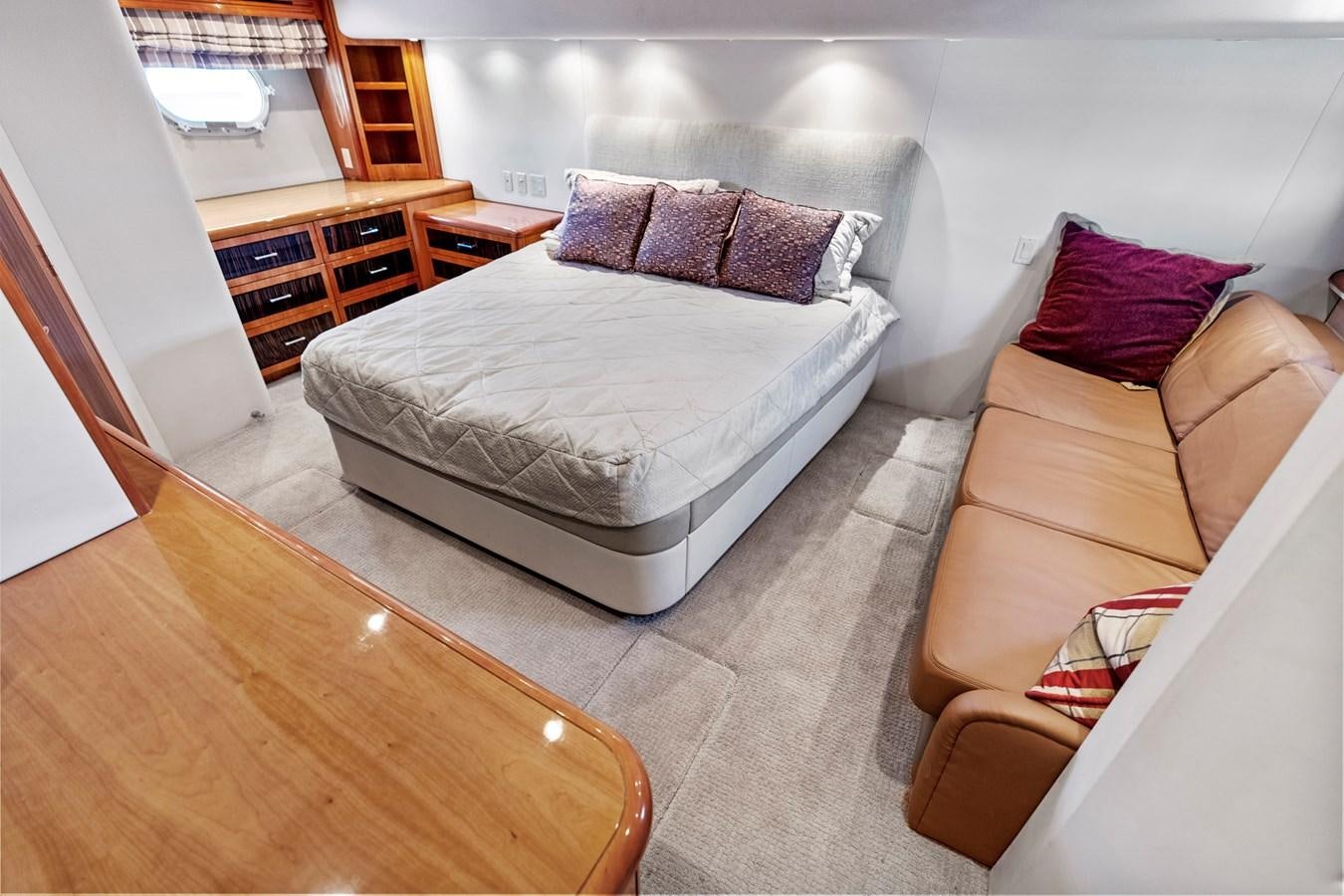 a bedroom with a bed and a couch aboard NAUTICAL NOMAD Yacht for Sale