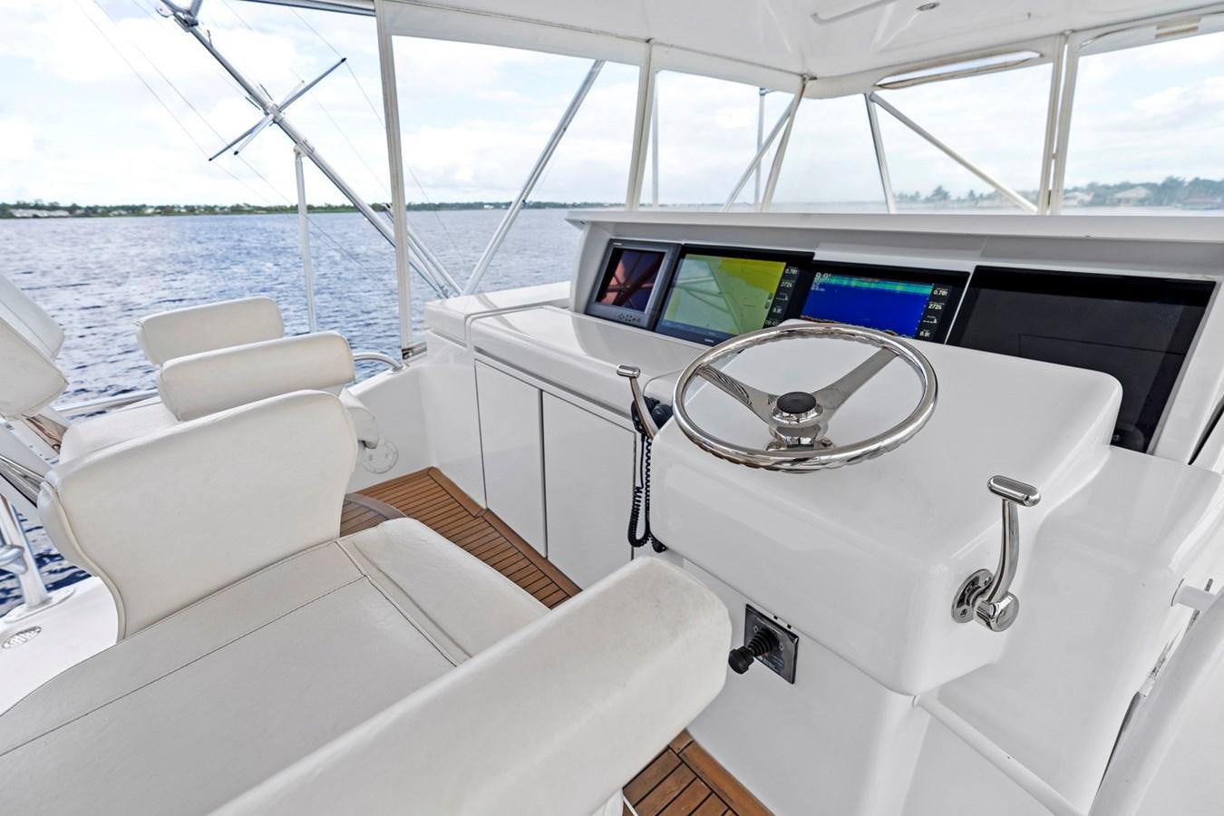 a boat with a steering wheel and seats on it aboard NAUTICAL NOMAD Yacht for Sale
