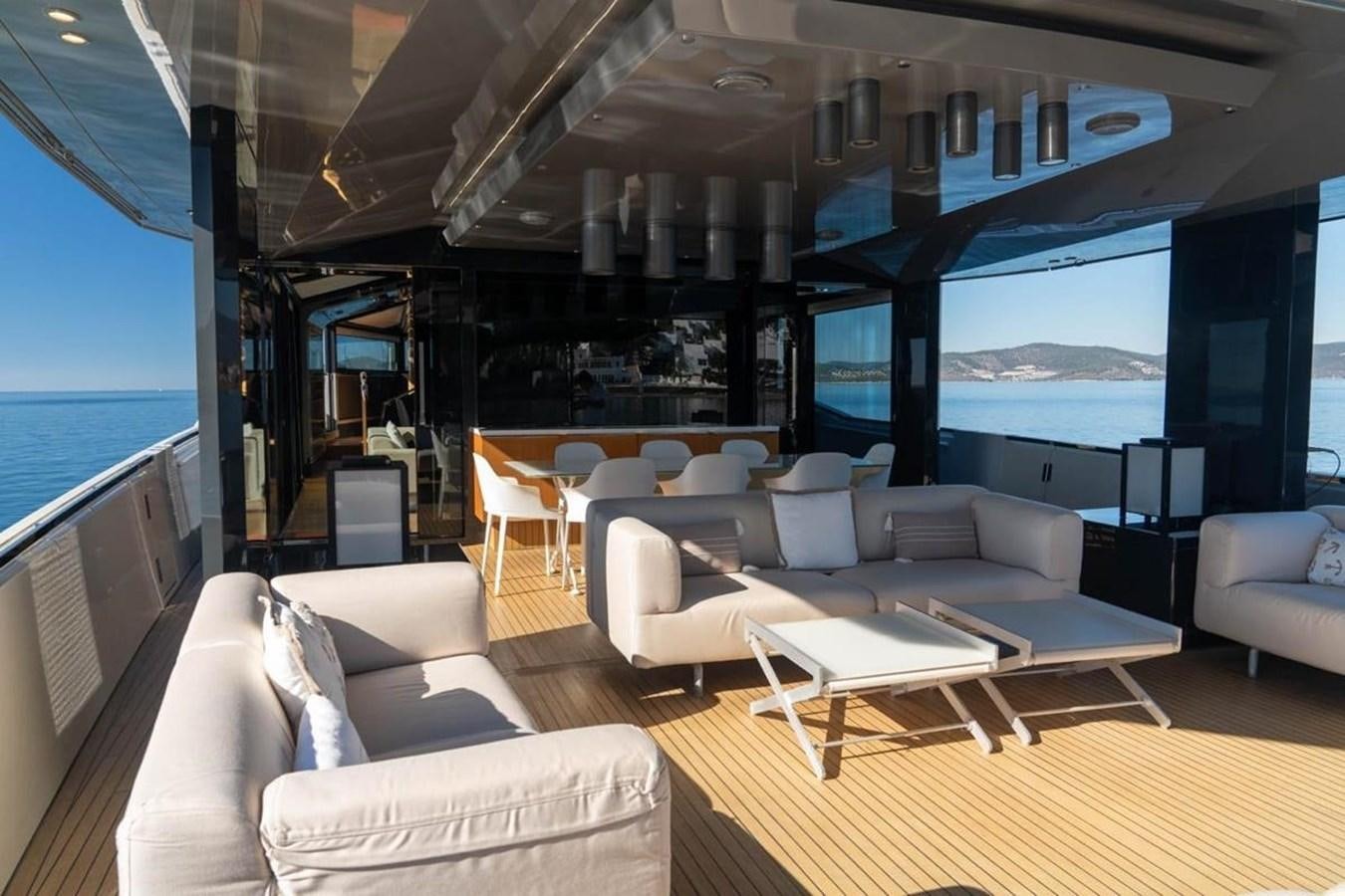 a room with a large window and a table with chairs and a large window aboard ARCADIA 85 2015 Yacht for Sale