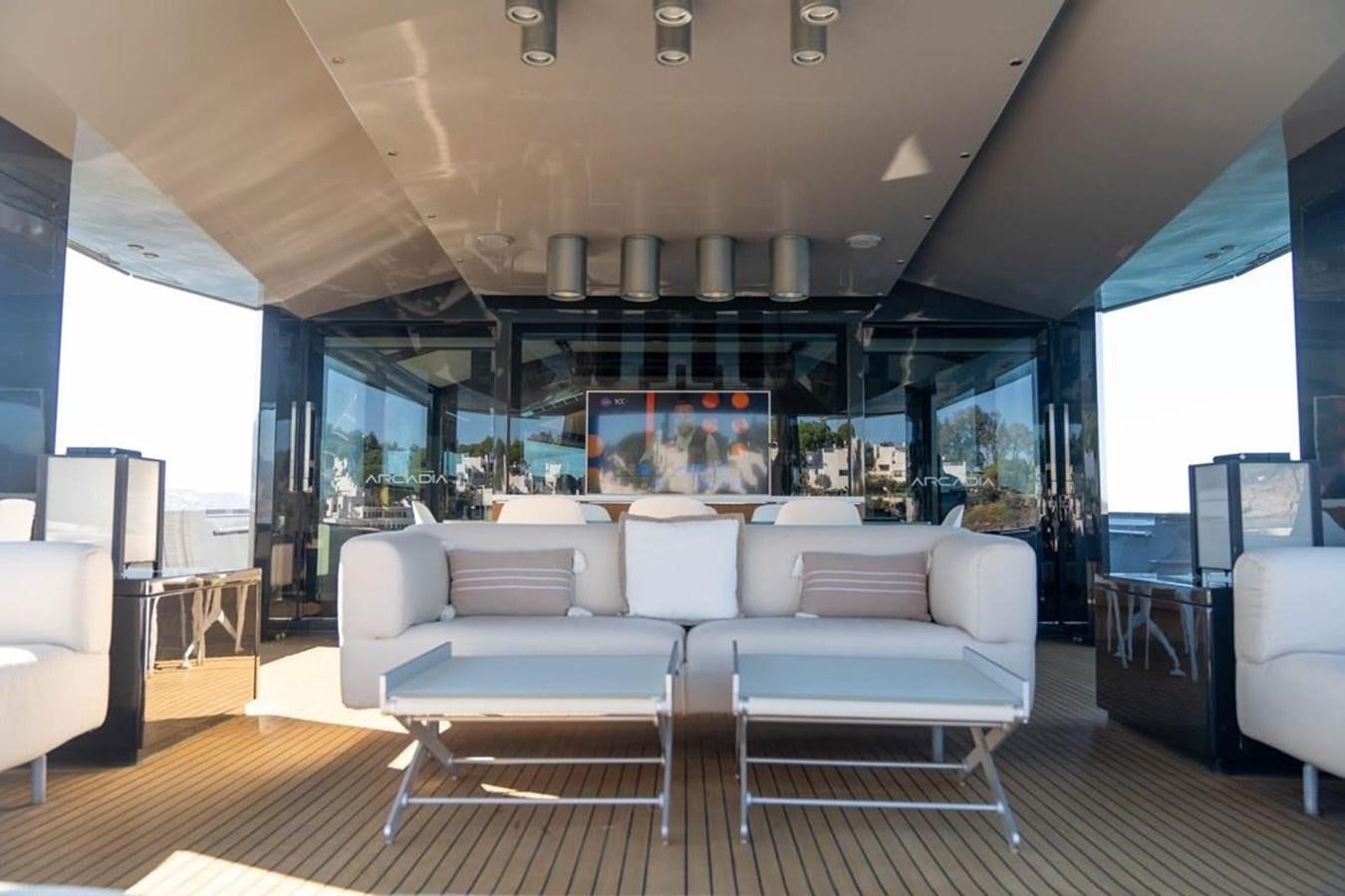 a living room with a large screen aboard ARCADIA 85 2015 Yacht for Sale