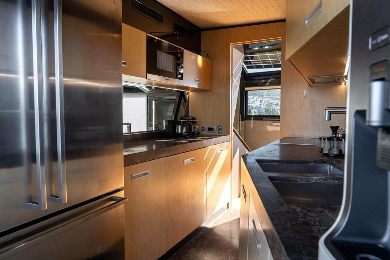 a kitchen with stainless steel appliances aboard ARCADIA 85 2015 Yacht for Sale
