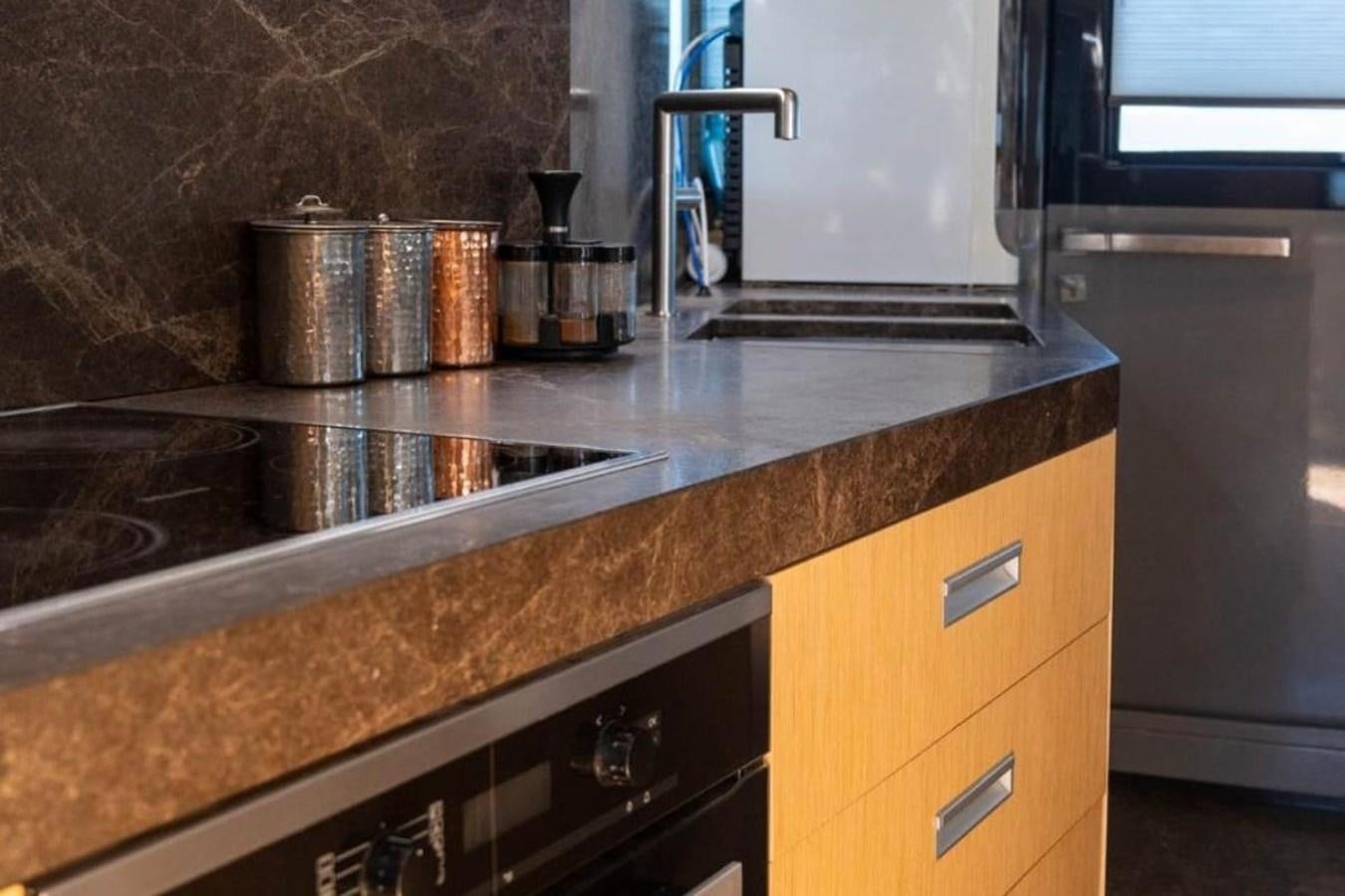 a kitchen with granite counter tops aboard ARCADIA 85 2015 Yacht for Sale