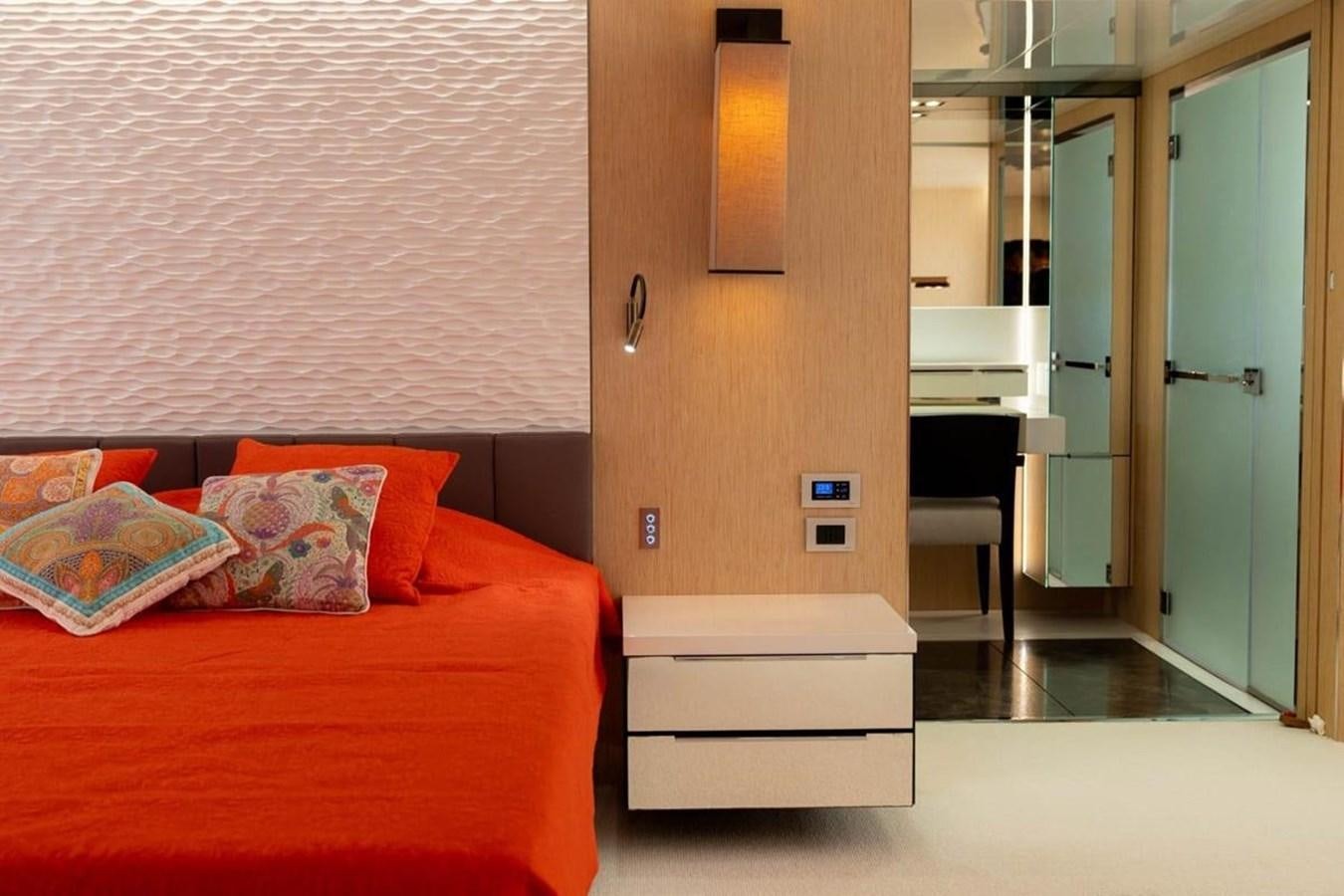 a bedroom with a bed and a desk aboard ARCADIA 85 2015 Yacht for Sale