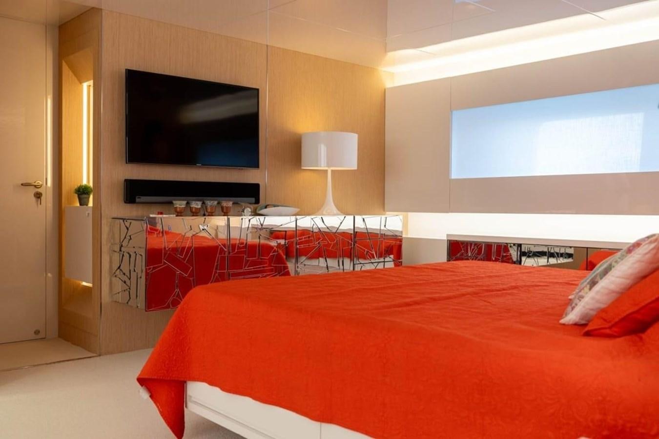 a bedroom with a bed and a tv aboard ARCADIA 85 2015 Yacht for Sale