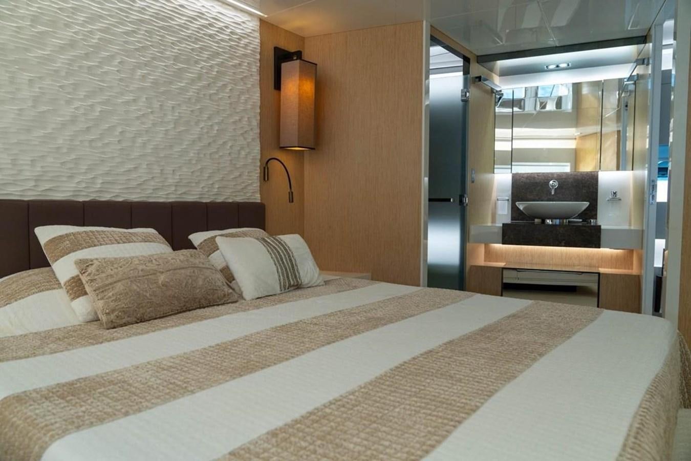 a bed with white sheets aboard ARCADIA 85 2015 Yacht for Sale