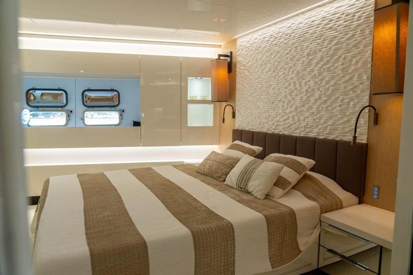 a bed in a room aboard ARCADIA 85 2015 Yacht for Sale