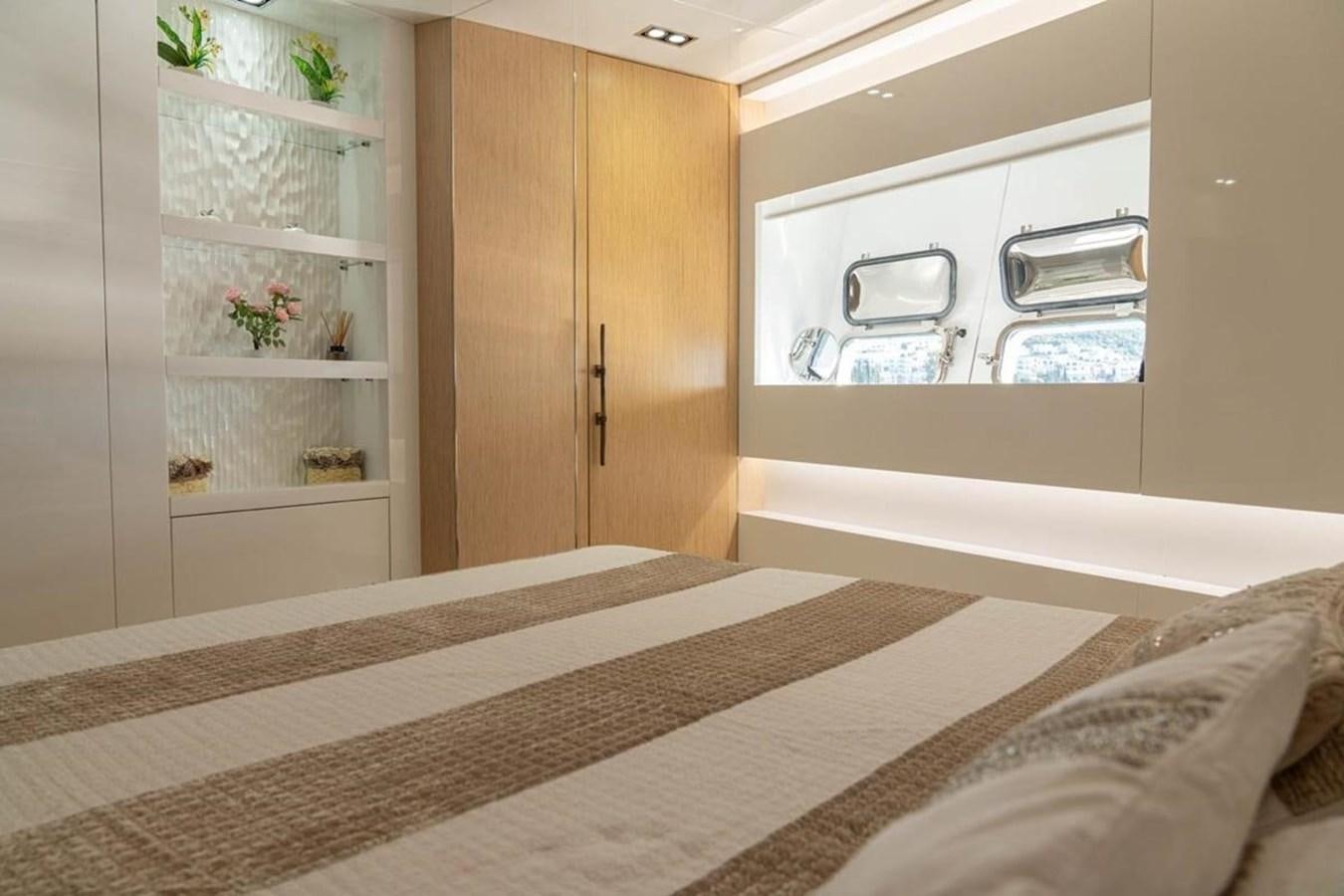 a room with a bed and cabinets aboard ARCADIA 85 2015 Yacht for Sale