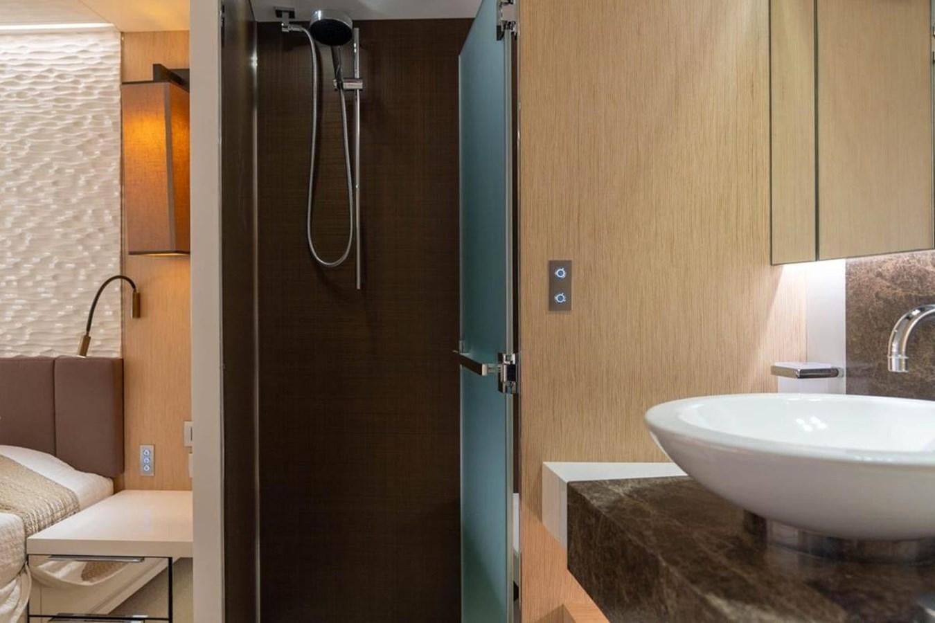 a bathroom with a sink and a shower aboard ARCADIA 85 2015 Yacht for Sale