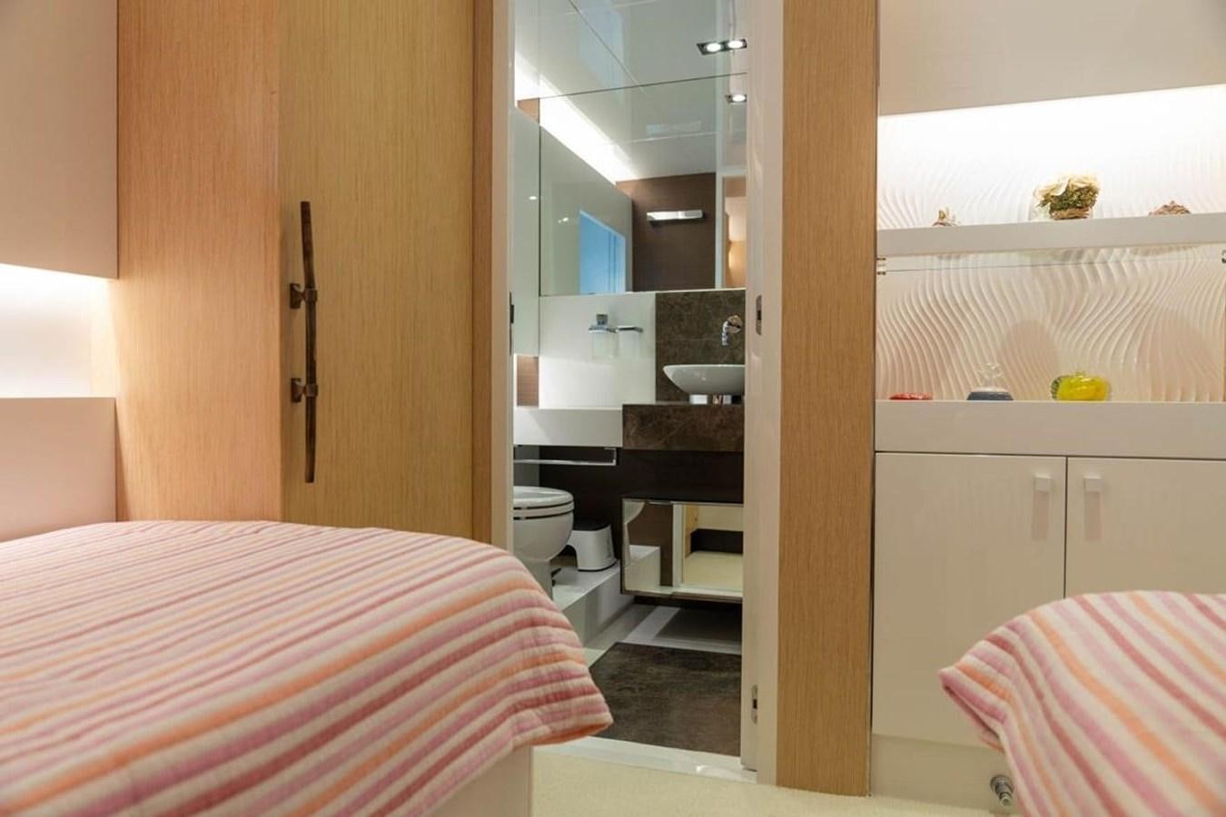 a bedroom with a sink and a bed aboard ARCADIA 85 2015 Yacht for Sale